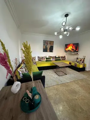 a living room with a couch and a table at Gueliz Appartement in Marrakech