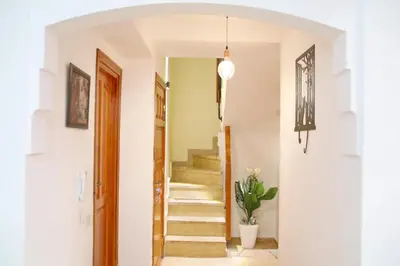 a hallway with stairs and a potted plant at Gueliz Appartement in Marrakech