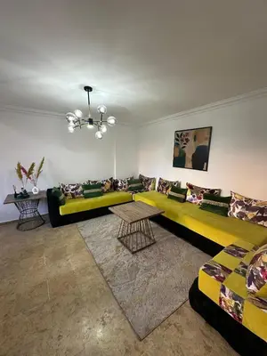 a living room with a couch and a table at Gueliz Appartement in Marrakech