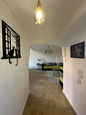 a living room with a black cat on the wall at Gueliz Appartement in Marrakech