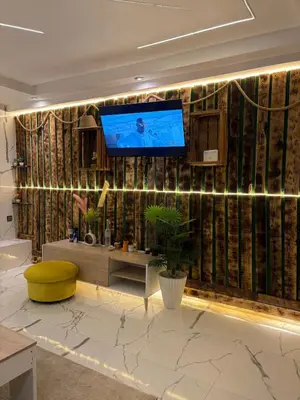 a living room with a tv on a wall at Apartment with pool in Marrakech