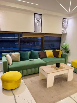 a living room with a green couch and a coffee table at Apartment with pool in Marrakech