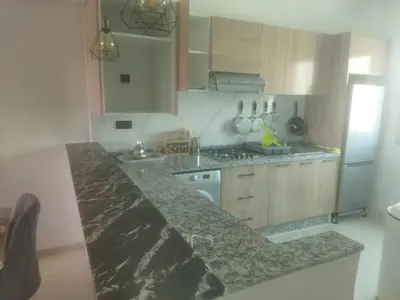 a kitchen with a counter top and a refrigerator at Appartement Marrakech in Marrakech