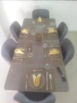 a table with utensils and plates of food on it at Appartement Marrakech in Marrakech