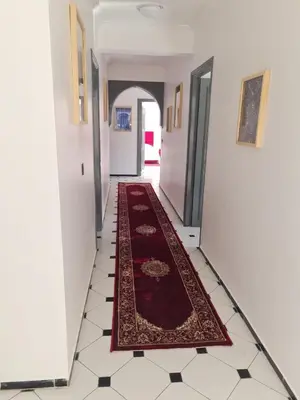 a hallway with a red rug on the floor at Apart plein centre in Marrakech