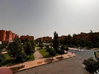 a view of a park with trees and buildings at Appartement a louer a massira 3 marrakech in Marrakech