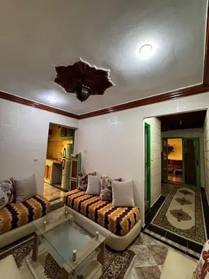 a living room with a couch and a glass table at Appartement a louer a massira 3 marrakech in Marrakech