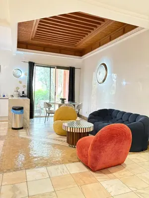 a living room with couches and chairs and a table at Appart villa de luxe avec 5 piscines in Marrakech