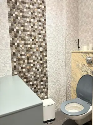 a bathroom with a toilet and a sink at Appart villa de luxe avec 5 piscines in Marrakech