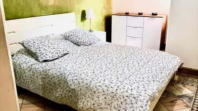 a bedroom with a bed with a white bedspread at Appart villa de luxe avec 5 piscines in Marrakech