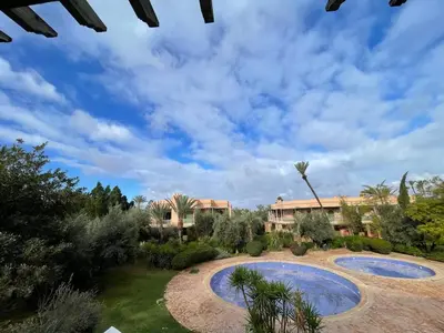 a view of a yard with two large pools at Appart villa de luxe avec 5 piscines in Marrakech