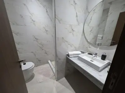 a white bathroom with a sink and a mirror at Appart-by-Ily-Avenue M VI -Agdal in Marrakech