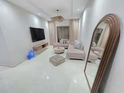 a living room with a mirror and a couch at Appart-by-Ily-Avenue M VI -Agdal in Marrakech