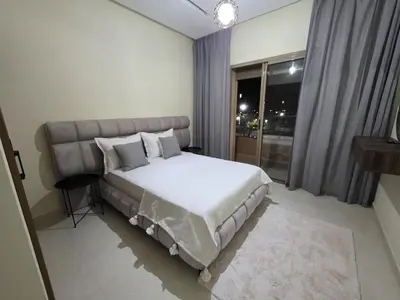 a bedroom with a large bed and a window at Appart-by-Ily-Avenue M VI -Agdal in Marrakech