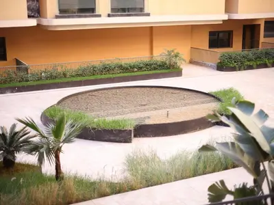 a building with a pool in the middle of a courtyard at Éden Luxueux au Cœur de la Ville in Marrakech
