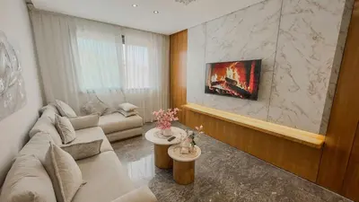 a living room with a couch and a table at Éden Luxueux au Cœur de la Ville in Marrakech