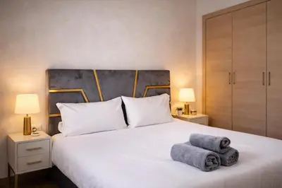 a bedroom with a white bed with towels on it at Marrakech prestige in Marrakech