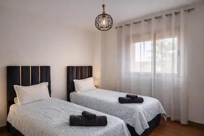 two beds sitting next to each other in a bedroom at Marrakech prestige in Marrakech