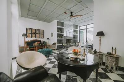 a living room with a table and chairs at Riad Palazzo Montefiore in Marrakech