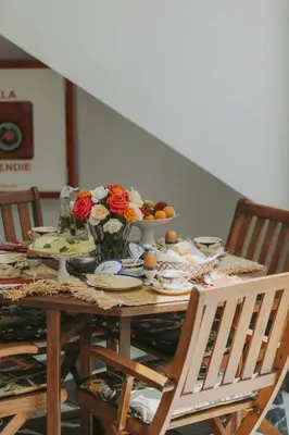 a dining room table with a bowl of food and flowers at Riad Palazzo Montefiore in Marrakech