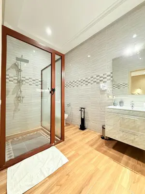 a bathroom with a shower and a tub and a sink at Villa ghina in Marrakech