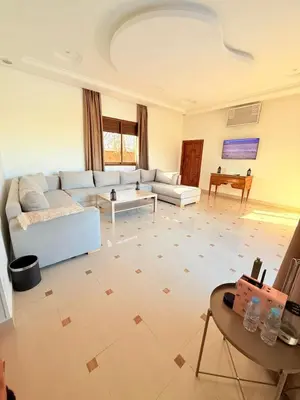 a living room with a couch and a table at Villa ghina in Marrakech
