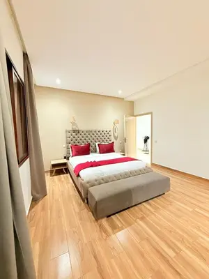 a large bedroom with a large bed with red pillows at Villa ghina in Marrakech