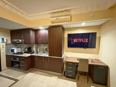 a kitchen with a kitchen island with a microwave at Trésor de Gueliz avec Piscine et Terrasse in Marrakech
