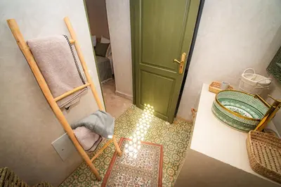 an overhead view of a bathroom with a green door at Riad Secret by Dar n alla in Marrakech