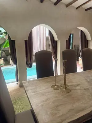 a wooden table with two vases on top of it at Riad Secret by Dar n alla in Marrakech