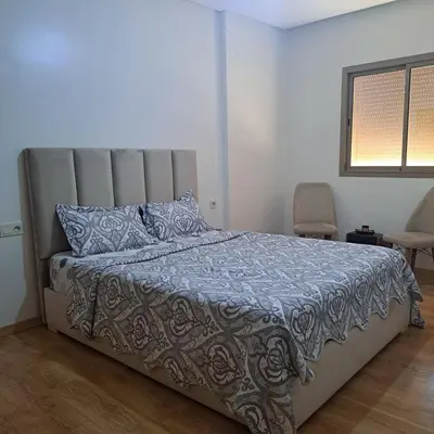 a bedroom with a bed with a gray comforter at Luxury 2 Bedrooms Apartment in Marrakech