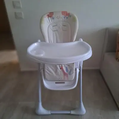 a white high chair sitting in a living room at Luxury 2 Bedrooms Apartment in Marrakech