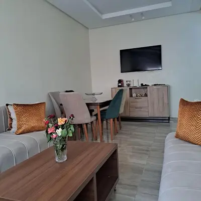 a living room with a vase of flowers on a table at Luxury 2 Bedrooms Apartment in Marrakech