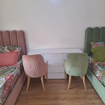 two chairs and a desk in a room with two beds at Luxury 2 Bedrooms Apartment in Marrakech