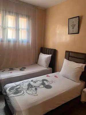 two beds sitting next to each other in a room at dar soukaina in Marrakech