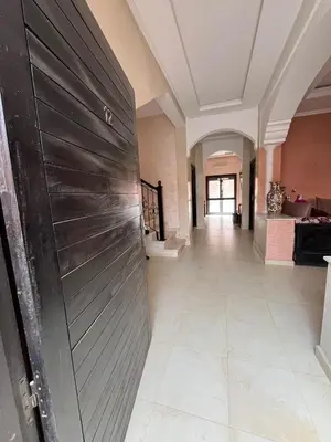 a hallway with a metal door in a house at Villa with private pool in Tamensourt