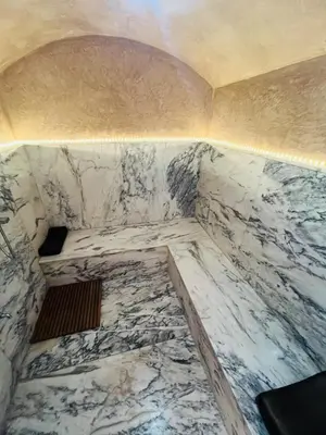 a corner of a room with a marble wall at Villa with private pool in Tamensourt