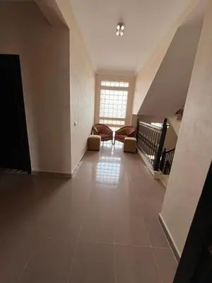 an empty hallway with chairs and a window at Villa with private pool in Tamensourt