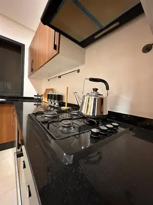 a kitchen with a stove with a tea kettle on it at appartement luxueux au centre vlle avec piscine in Marrakech