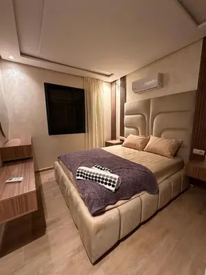 a bedroom with a bed with a guitar on it at appartement luxueux au centre vlle avec piscine in Marrakech