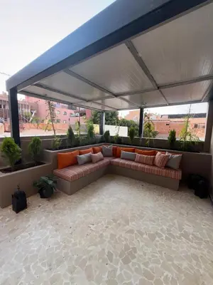 a couch under a canopy on a roof at Appartement de luxe à gueliz neuf et moderne in Marrakech