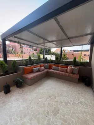 a couch under a canopy on a patio at Appartement de luxe à gueliz neuf et moderne in Marrakech