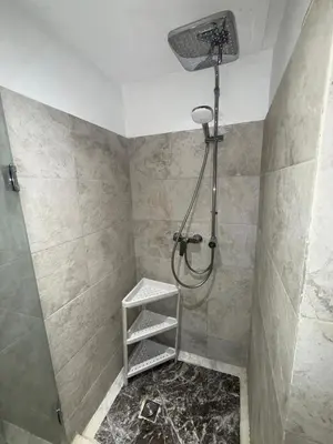 a bathroom with a shower with a ladder and a shelf at Appartement de luxe à gueliz neuf et moderne in Marrakech