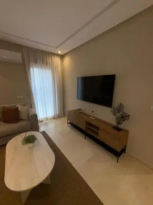 a living room with a flat screen tv on the wall at Appartement de luxe à gueliz neuf et moderne in Marrakech