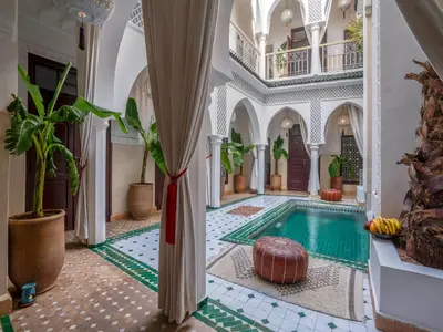 an indoor pool in a house with a room with a ceiling at Riad Fleur De Sable in Marrakech
