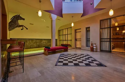 a lobby with a checkered floor and a horse on the wall at Zen Zone Boutique Riad & Spa in Marrakech