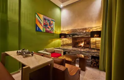 a living room with green walls and a fireplace at Zen Zone Boutique Riad & Spa in Marrakech