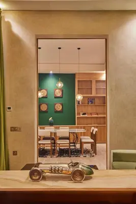 a dining room with a table and a green wall at Zen Zone Boutique Riad & Spa in Marrakech