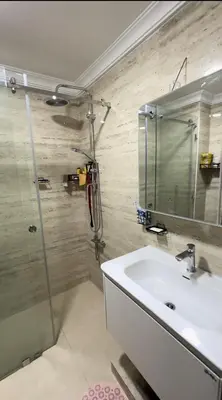 a bathroom with a sink and a shower with a mirror at Sofia Palmeraie - High standing in Marrakech