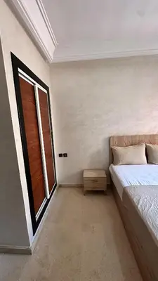 a bedroom with a bed and a window at Sofia Palmeraie - High standing in Marrakech